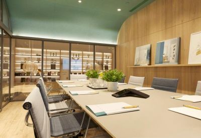 Modern meeting room with light wood walls and a mint green ceiling.