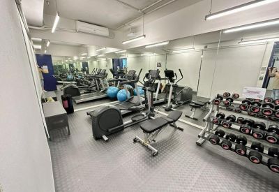 On-site gym facility with treadmills, elliptical trainers, and a weight rack.