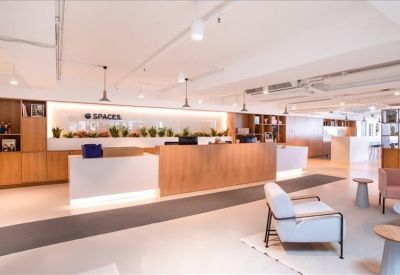 Bright, modern reception area with wooden desk and lounge seating.