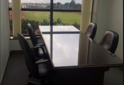 Six-person conference room with a polished dark table and large windows offering harbor views.