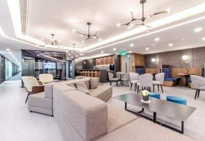 Modern lounge and coworking area with various seating options and designer chandeliers.