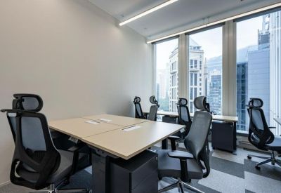 Private office suite with multiple workstations and large windows overlooking the city.