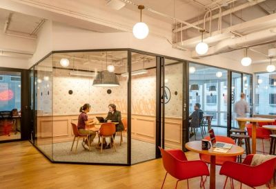 Meeting room with glass walls and light wood paneling.