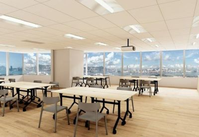 Spacious training room with multiple modular tables and city views.