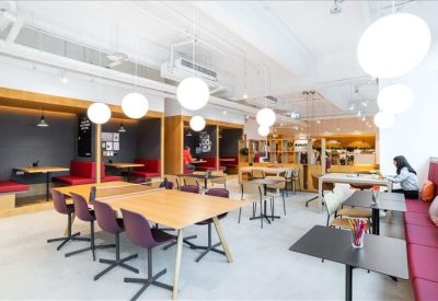 Spacious communal lounge and cafe area with globe pendant lighting and diverse seating.