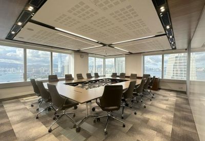 Large boardroom featuring a hollow square table setup under a contemporary recessed ceiling.
