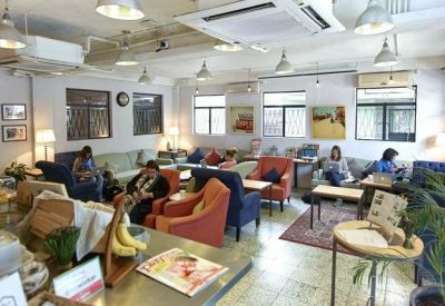 Spacious lounge area with colorful armchairs and comfortable sofas for informal meetings.