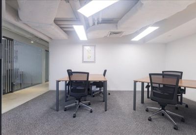 Compact three-person private office suite with carpeted floor.