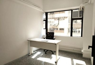 Private one-person office with a white desk and a window view.