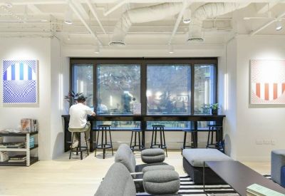 Cozy lounge with window seating and wall art.