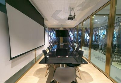Meeting room with a large projector screen and glass-walled conference area.