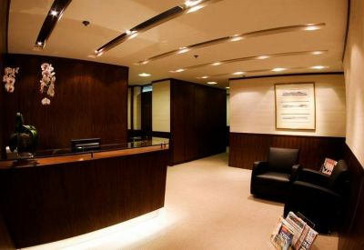 Professional reception area with dark wood paneling and warm accent lighting.