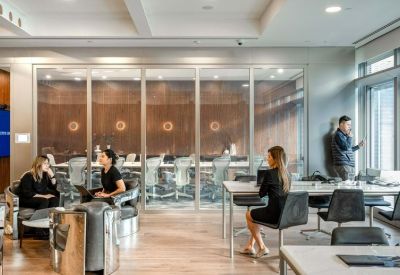 Modern coworking area with glass partitions and natural light.
