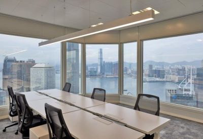 Professional meeting room featuring a long wooden table and panoramic harbor views.