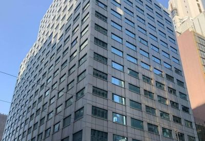 The high-rise exterior of the China Insurance Group Building against a clear sky.