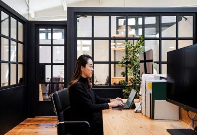 Private office suite featuring a glass partition and a professional workstation.