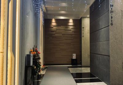 Stylish hallway with recessed lighting and a textured accent wall.