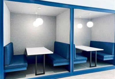 Built-in private meeting booths with blue seating and spherical pendant lights.