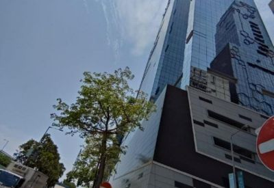 Exterior of King Palace Plaza, a modern glass skyscraper against a bright sky.