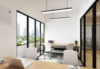 Bright private office with floor-to-ceiling windows and wood-topped desks.