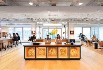 Reception desk featuring warm wooden panels with artistic circular designs.
