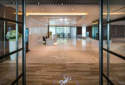 Spacious reception lobby with polished floors and a modern white front desk.