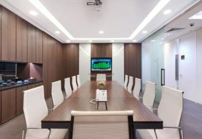 Boardroom with dark wood panelling and a long conference table.