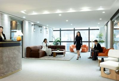 Modern reception lobby with a marble desk and seating area.