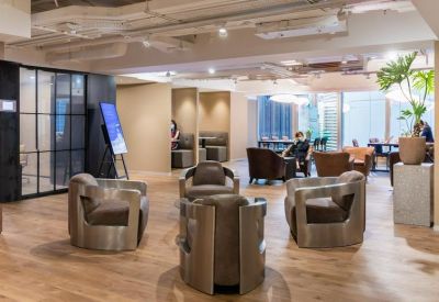 Modern coworking area with unique metallic circular armchairs and breakout booths.