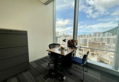 Private window office with a wooden desk and views of the city skyline.