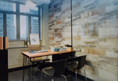 A modern meeting room with glass walls, wood-paneled accents, and a view of the city skyline.