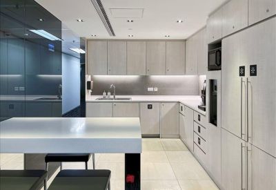 Clean, modern kitchen area with white cabinetry and integrated appliances.