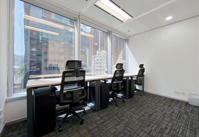 Private office with ergonomic chairs and city views through large windows.