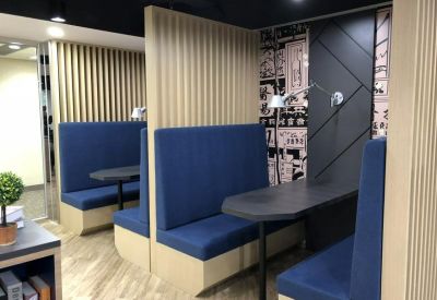 Semi-private blue upholstered booths for focused collaboration.