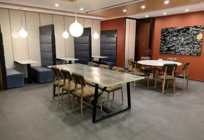Spacious communal lounge and dining area with feature lighting and modern art.
