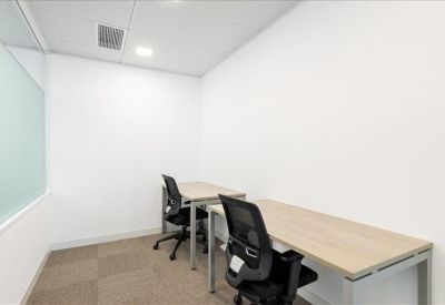 Private two-person internal office suite with sleek white walls and tan carpeting.