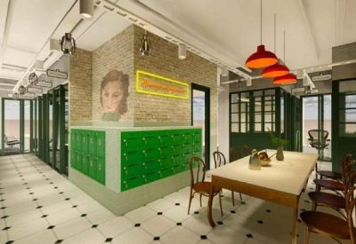 Vibrant coworking space with green lockers, exposed brick walls, and a large wooden communal table.