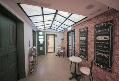 Themed corridor with brick-effect walls, skylights, and framed bistro menus.