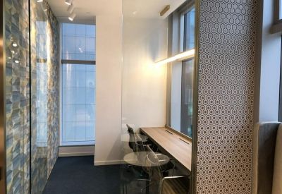 Private workstation nook with a wooden desk and patterned privacy screens.