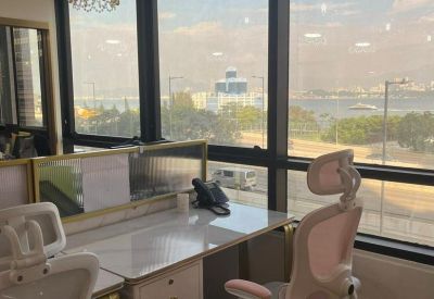 Close-up of a bright workstation with a harbor view and decorative crystal pendant lamps.