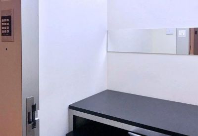 Private office pod with a black desk and secure keypad entry.