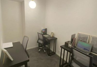 Compact private office with three workstations and modern globe pendant lights.