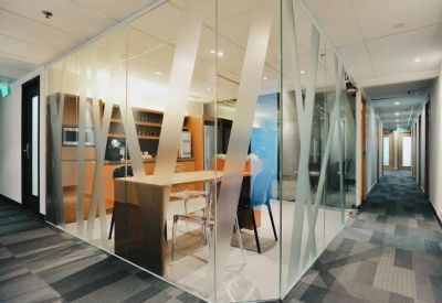 A modern glass-walled meeting room with decorative frosted patterns at Silvercord Tower 2.
