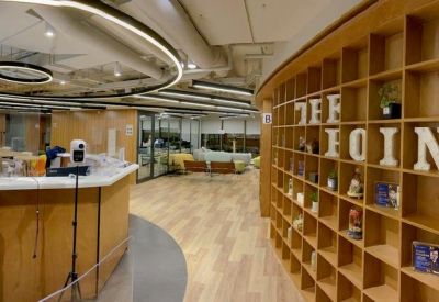 Spacious reception area at New Mandarin Plaza with wood paneling and a curved front desk.