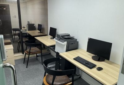 Small three-person office suite with workstations and a printer.
