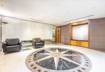 Bright lobby area with a large inlaid compass design on the polished marble floor.