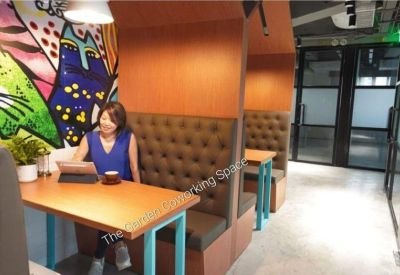 Private dining or meeting booths with brown tufted leather seating and colorful wall art.