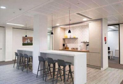 Contemporary office kitchen and dining area with high-top breakfast bars and bar stools.