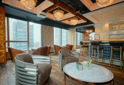 Elegant lounge area with velvet chairs and crystal chandeliers.