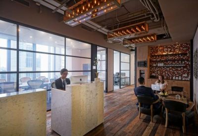 Reception desk area with industrial-style lighting and wood accents.